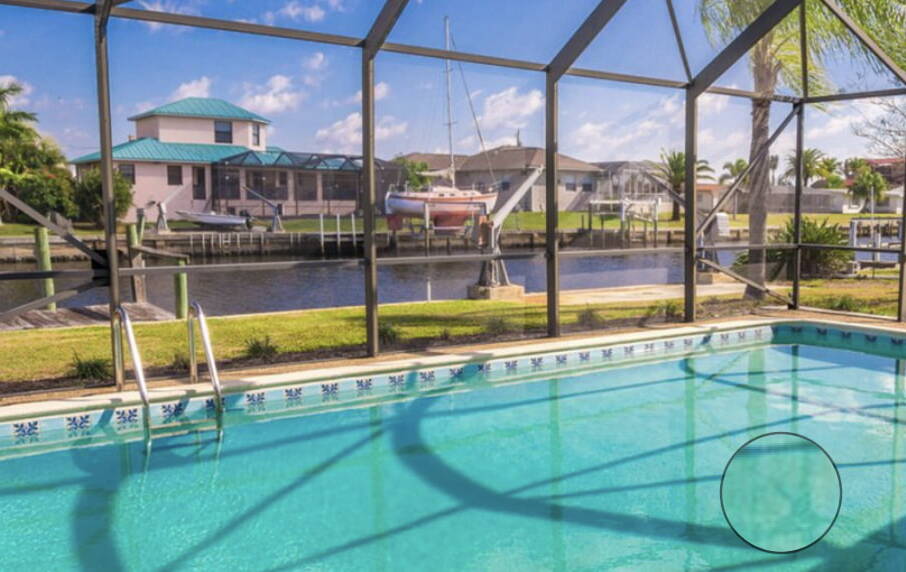  A pool area with a beautiful and functional pool cage