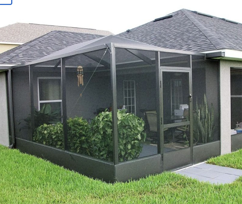 A photo of an aluminum screen porch with white frames and a screened roof.