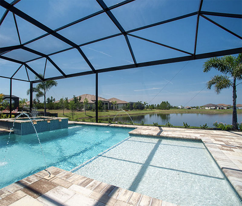 A lanai builder measuring and cutting materials for a new installation