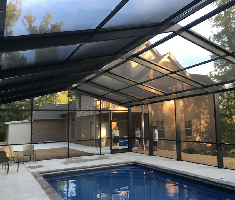 A lanai renovation in progress, with workers installing new materials and updating the space