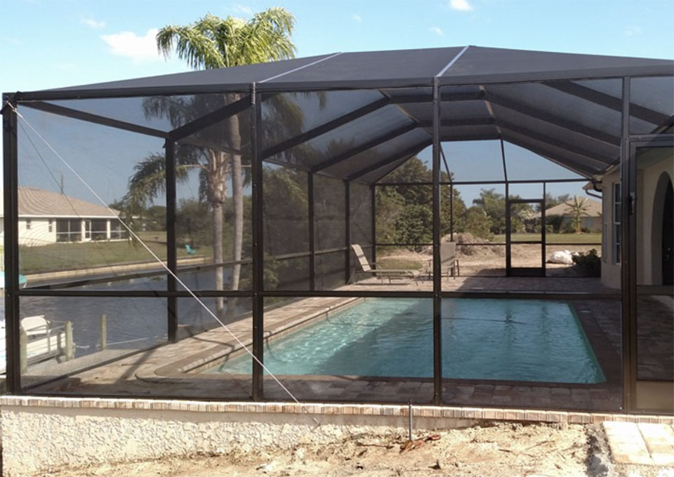 A porch contractor installing a screen door on a porch in Florida